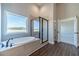 Bright bathroom featuring a freestanding tub with a window and a glass shower at 1422 Alcovy Station Rd, Covington, GA 30014