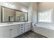 Elegant bathroom with double vanity, soaking tub, and walk-in shower at 1422 Alcovy Station Rd, Covington, GA 30014