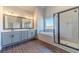 Modern bathroom featuring double vanity, freestanding tub, and glass enclosed shower at 1422 Alcovy Station Rd, Covington, GA 30014