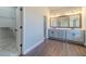 Bathroom featuring double vanity, a large mirror, and access to the walk-in closet at 1422 Alcovy Station Rd, Covington, GA 30014