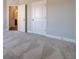 Bedroom with plush carpeting and a door to another room, showcasing seamless transitions at 1422 Alcovy Station Rd, Covington, GA 30014