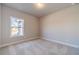 Bedroom with plush carpeting and a bright window with views of the outdoors at 1422 Alcovy Station Rd, Covington, GA 30014