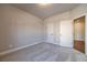 An empty bedroom is shown with plush gray carpet and an entrance to another room at 1422 Alcovy Station Rd, Covington, GA 30014