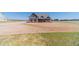 Charming exterior of a gray farmhouse-style home with a spacious yard and long driveway on a bright day at 1422 Alcovy Station Rd, Covington, GA 30014