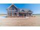 This craftsman-style home has a brick-foundation, gray siding and wood-look shutters at 1422 Alcovy Station Rd, Covington, GA 30014