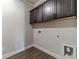 The laundry room shows dark cabinets and hookups for a washer and dryer at 1422 Alcovy Station Rd, Covington, GA 30014