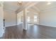 Bright living room features wood floors, white trim, elegant lighting, and an open layout to the rest of the house at 1422 Alcovy Station Rd, Covington, GA 30014