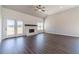 Bright living room featuring a white brick fireplace, wood floors, and natural light from the french doors at 1422 Alcovy Station Rd, Covington, GA 30014