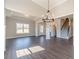 Bright living room features wood floors, white trim, elegant lighting, and an open layout to the rest of the house at 1422 Alcovy Station Rd, Covington, GA 30014