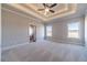 Spacious main bedroom with trey ceiling, recessed lighting, and plush carpet with views to the exterior at 1422 Alcovy Station Rd, Covington, GA 30014