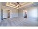 Large main bedroom with neutral walls and plush carpet, showcasing multiple doors at 1422 Alcovy Station Rd, Covington, GA 30014