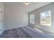 Cozy bedroom featuring two windows, neutral walls, and carpet flooring at 1434 Alcovy Station Rd, Covington, GA 30014