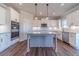 Bright kitchen features a gray island, white cabinets, and stainless steel appliances at 1434 Alcovy Station Rd, Covington, GA 30014