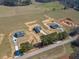 Aerial view of three homes with long driveways and large grassy lots in a rural area at 1452 Alcovy Station Rd, Covington, GA 30014
