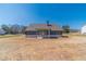 Back of new construction home with long driveway and large, grassy backyard on sunny day at 1452 Alcovy Station Rd, Covington, GA 30014