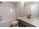 Bathroom features a shower-tub combination and stylish dark wood vanity with quartz countertop at 1452 Alcovy Station Rd, Covington, GA 30014