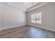 Bright bedroom with hardwood floors, tray ceiling, and large window with wooded views at 1452 Alcovy Station Rd, Covington, GA 30014