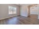 Bedroom with hardwood floors, tray ceiling, a large window with wooded view, and entry view at 1452 Alcovy Station Rd, Covington, GA 30014