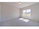 Bright, carpeted bedroom with a large window offering natural light and scenic views at 1452 Alcovy Station Rd, Covington, GA 30014