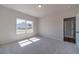 Comfortable carpeted bedroom featuring a large window and adjacent bathroom at 1452 Alcovy Station Rd, Covington, GA 30014