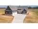 Charming craftsman home boasts a three-car garage and a beautifully landscaped front yard at 1452 Alcovy Station Rd, Covington, GA 30014