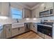 Kitchen with gray cabinets, stainless steel appliances, and subway tile backsplash at 1452 Alcovy Station Rd, Covington, GA 30014