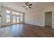 Bright living room featuring a ceiling fan, wood floors, and double doors leading outside at 1452 Alcovy Station Rd, Covington, GA 30014