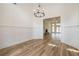 Elegant living room with wainscoting and hardwood floors leading to a room with a fireplace at 1452 Alcovy Station Rd, Covington, GA 30014