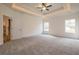 Spacious main bedroom with carpeted floors, tray ceiling, and barn door at 1452 Alcovy Station Rd, Covington, GA 30014