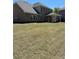 Brick home featuring a lush, newly sodded backyard and covered patio at 5000 Fairview Cir, Villa Rica, GA 30180