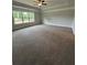 Spacious bedroom with tray ceiling, ceiling fan, neutral paint and plush carpeting at 5000 Fairview Cir, Villa Rica, GA 30180