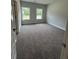 Bright bedroom with two windows and plush carpet flooring, offering a cozy and inviting space at 5000 Fairview Cir, Villa Rica, GA 30180
