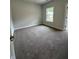 Carpeted bedroom with a window allowing natural light to filter in at 5000 Fairview Cir, Villa Rica, GA 30180