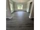 Formal dining room with large windows and decorative wall trim and gray wood floors at 5000 Fairview Cir, Villa Rica, GA 30180