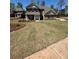 Charming two-story home with a well-manicured lawn and classic architectural details at 5000 Fairview Cir, Villa Rica, GA 30180