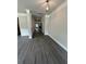 Well-lit hallway with gray wood floors and white trim create a modern aesthetic at 5000 Fairview Cir, Villa Rica, GA 30180