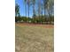 Expansive property with a golf course view, enhanced by natural landscaping and mature trees at 5000 Fairview Cir, Villa Rica, GA 30180