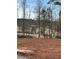 Expansive property with a golf course view, enhanced by natural landscaping and mature trees at 5000 Fairview Cir, Villa Rica, GA 30180