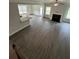 Spacious living area featuring modern wood floors, fireplace, and ample natural light from multiple windows at 5000 Fairview Cir, Villa Rica, GA 30180