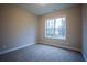 Neutral bedroom features large window letting in natural light and plush carpeting at 37 Harmony Ridge Dr, Temple, GA 30179