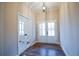 Inviting entryway featuring white double doors, hardwood floors, and an elegant pendant light at 37 Harmony Ridge Dr, Temple, GA 30179