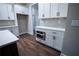 Modern kitchen with white cabinets, stainless steel appliances, subway tile backsplash and hardwood flooring at 37 Harmony Ridge Dr, Temple, GA 30179