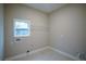 Tiled laundry room featuring bright natural light and wire rack shelving at 37 Harmony Ridge Dr, Temple, GA 30179