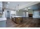 Open concept kitchen flows into the living room with a fireplace and built-in shelving at 37 Harmony Ridge Dr, Temple, GA 30179