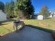 Spacious backyard with raised garden beds, storage shed, and mature trees at 6090 Kingston Ln, Mcdonough, GA 30253