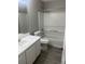 Clean bathroom with white vanity, bathtub, and shower at 6090 Kingston Ln, Mcdonough, GA 30253