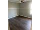 Spacious bedroom with ceiling fan and wood-look floors at 6090 Kingston Ln, Mcdonough, GA 30253