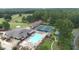 Resort-style pool, tennis courts, and clubhouse with surrounding green space at 7042 Confederate Ct, Villa Rica, GA 30116