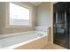 Relaxing bathroom with a soaking tub and tiled flooring at 7042 Confederate Ct, Villa Rica, GA 30116