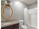 Well-lit bathroom with granite countertop, oval mirror, and shower/tub at 7042 Confederate Ct, Villa Rica, GA 30116